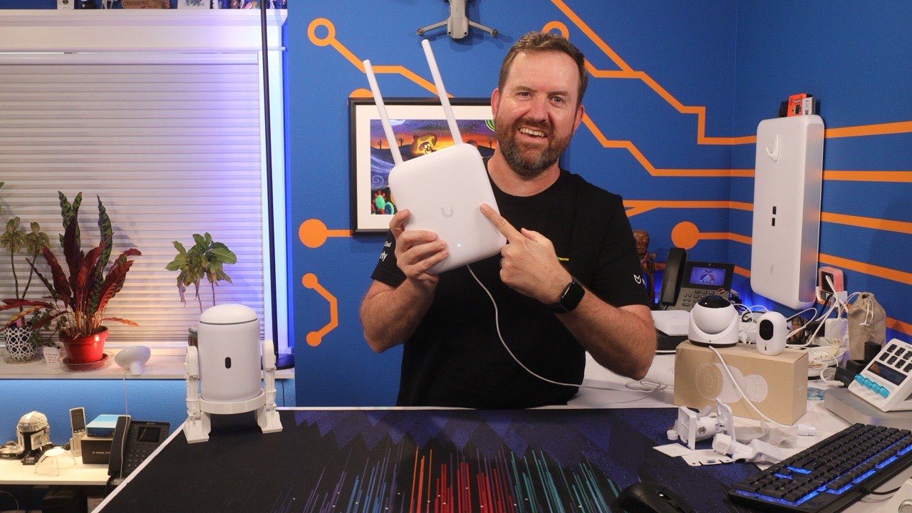 Chris Sherwood reviewing a UniFi router in the Crosstalk Solutions studio